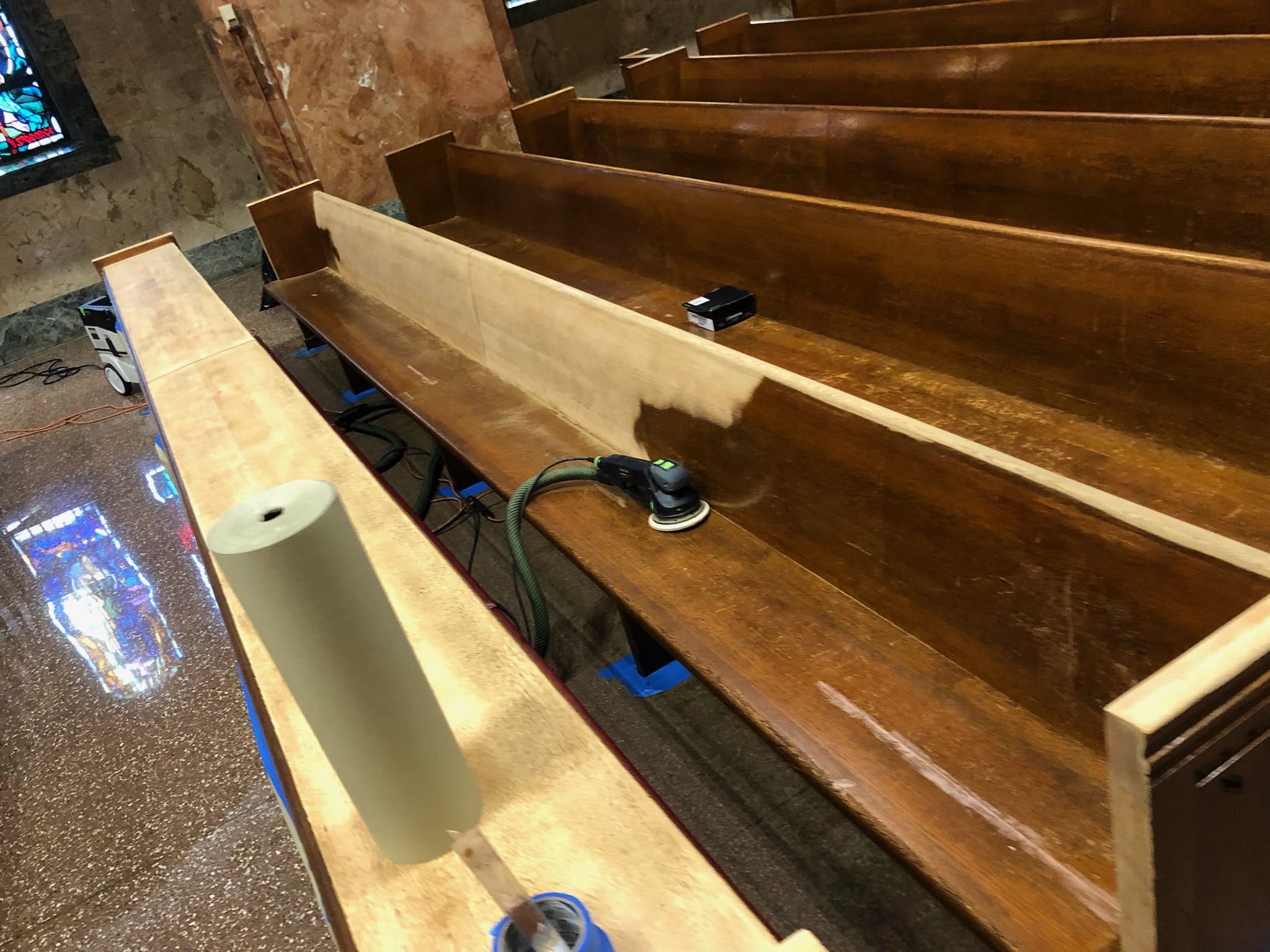 Empty, dark wooden pews with a polished finish.