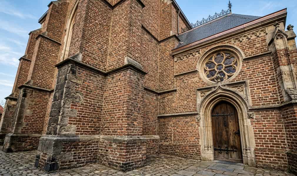 A historic brick church building with a large wooden door