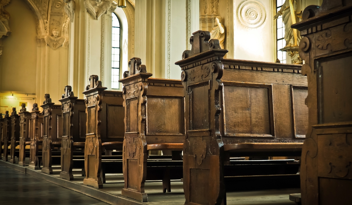 dark wooden church pews inside an old cathedral