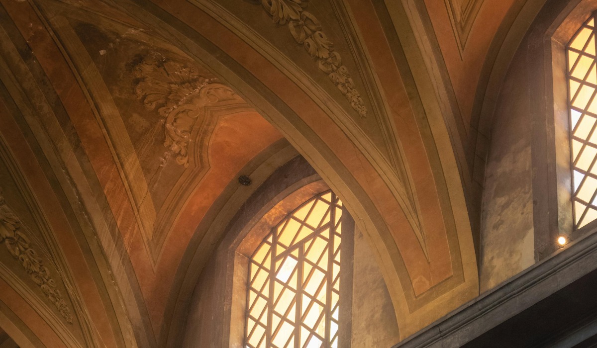 vaulted church ceiling with warm-toned fresco paintings