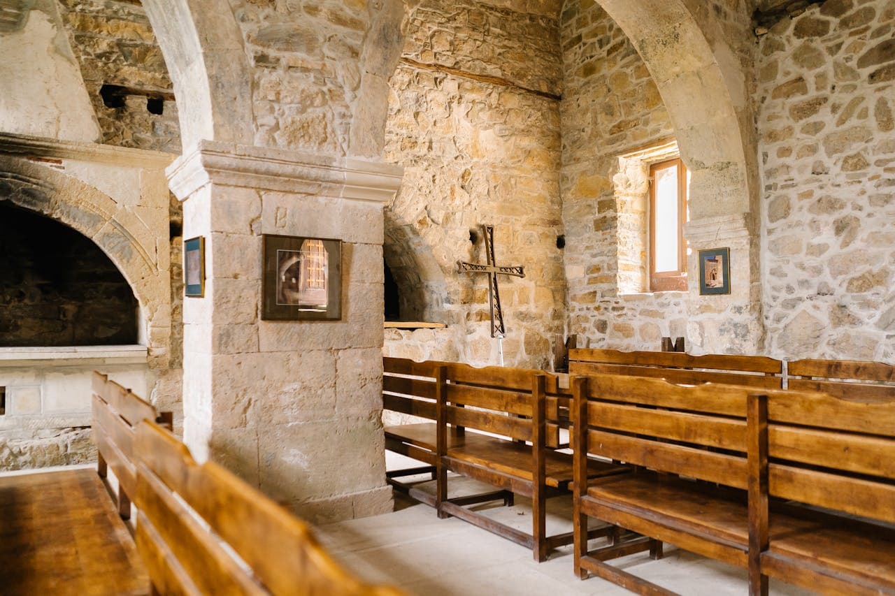 Historical stone walled church with old pews