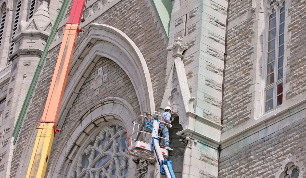 restoring the stone facade of a historic gothic church