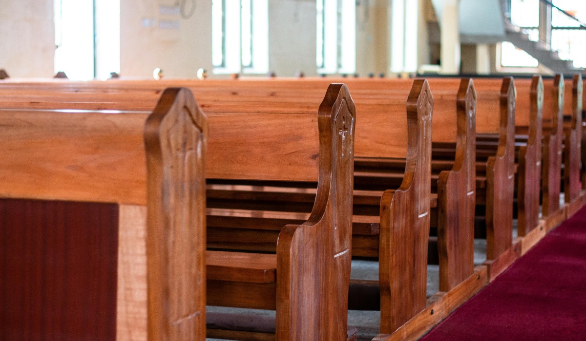 Rows of empty wooden church pews