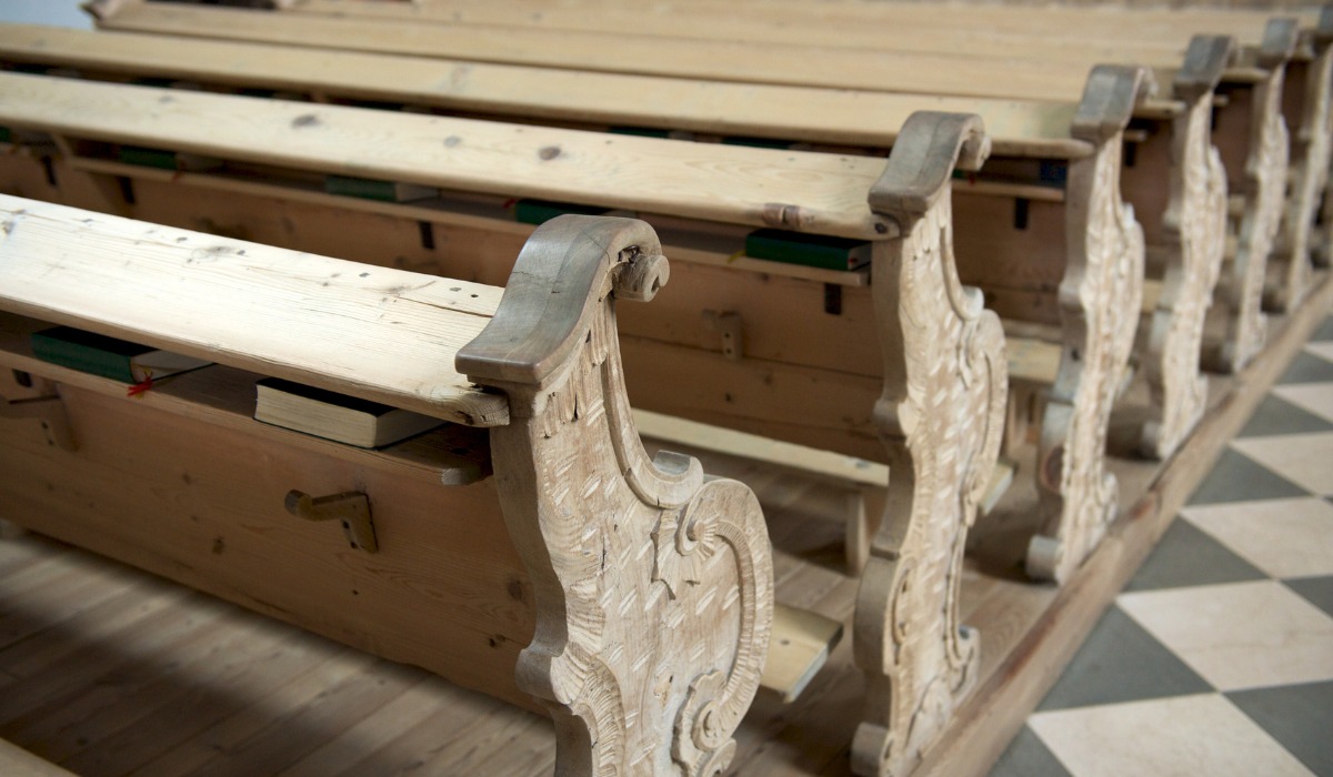 ornately carved wooden church pews