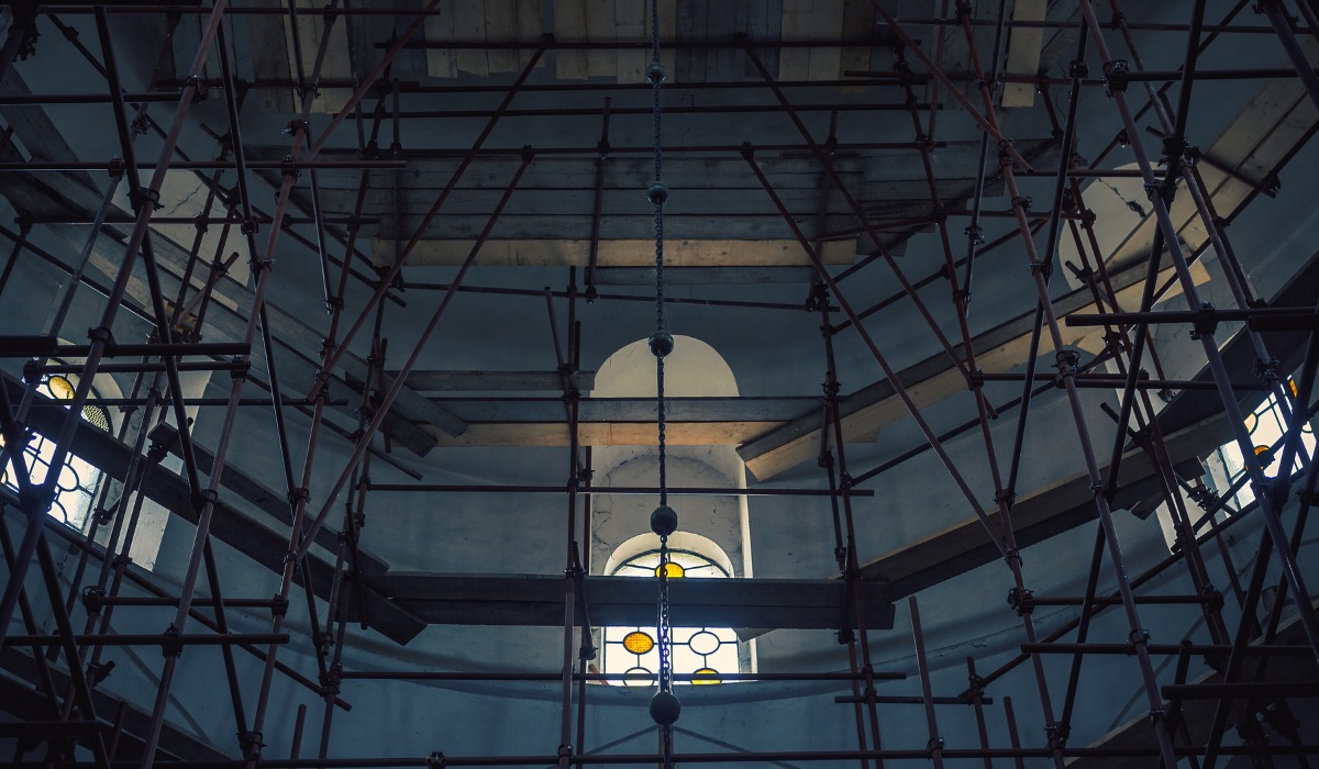 metal scaffolding inside an arched building interior