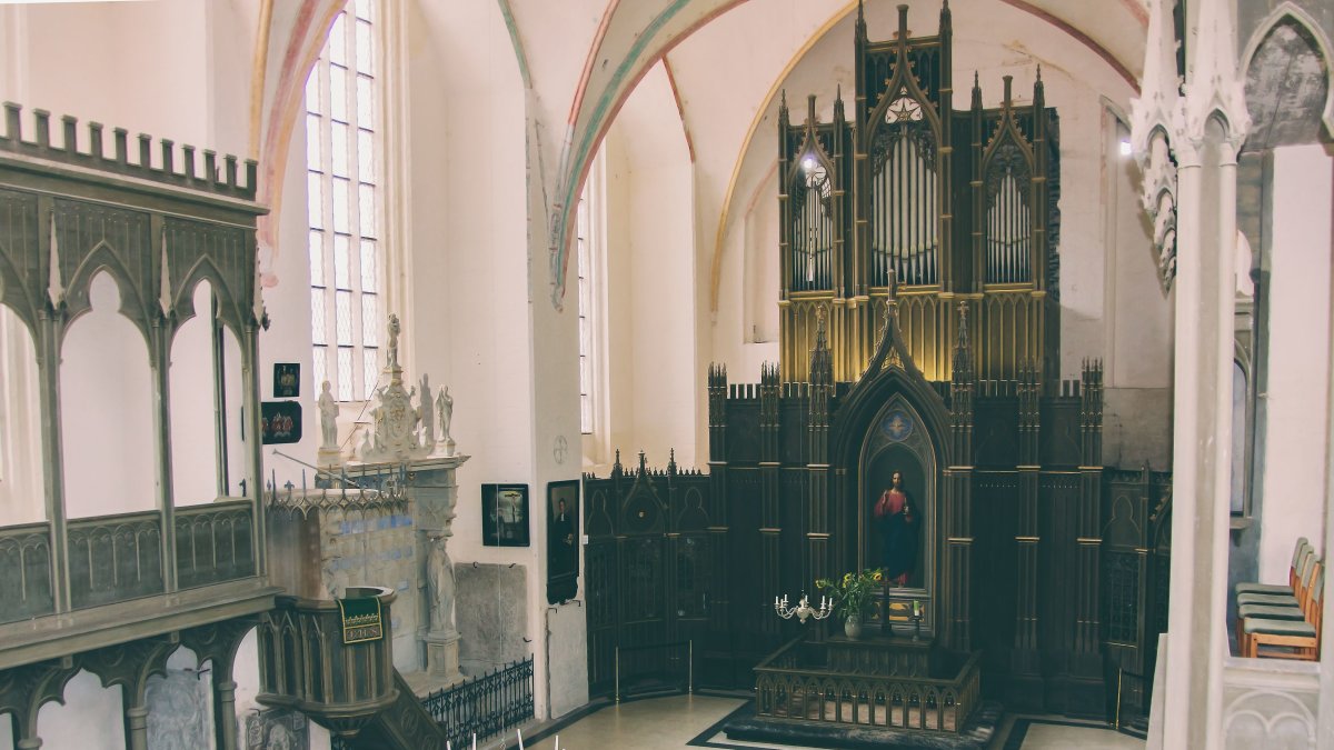 Intricately detailed historical Gothic church interior with an ornate altar