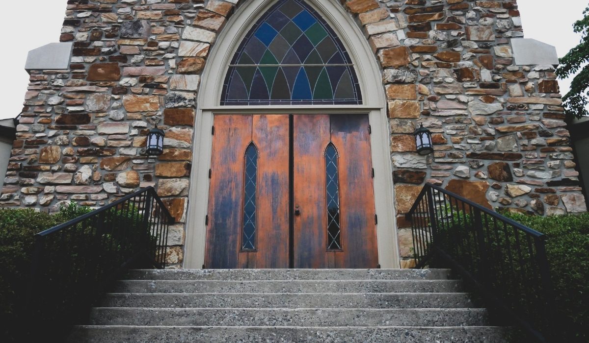Gothic-style entrance featuring large double doors