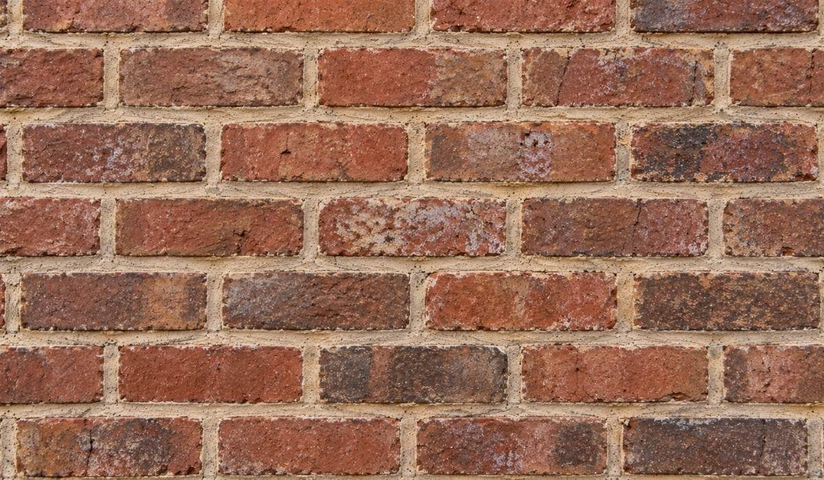 finished lime-mortar repointing project on a historic red-brick Catholic church
