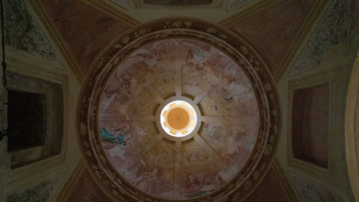 Ornate dome ceiling with intricate fresco artwork showcasing detailed historic paint techniques.