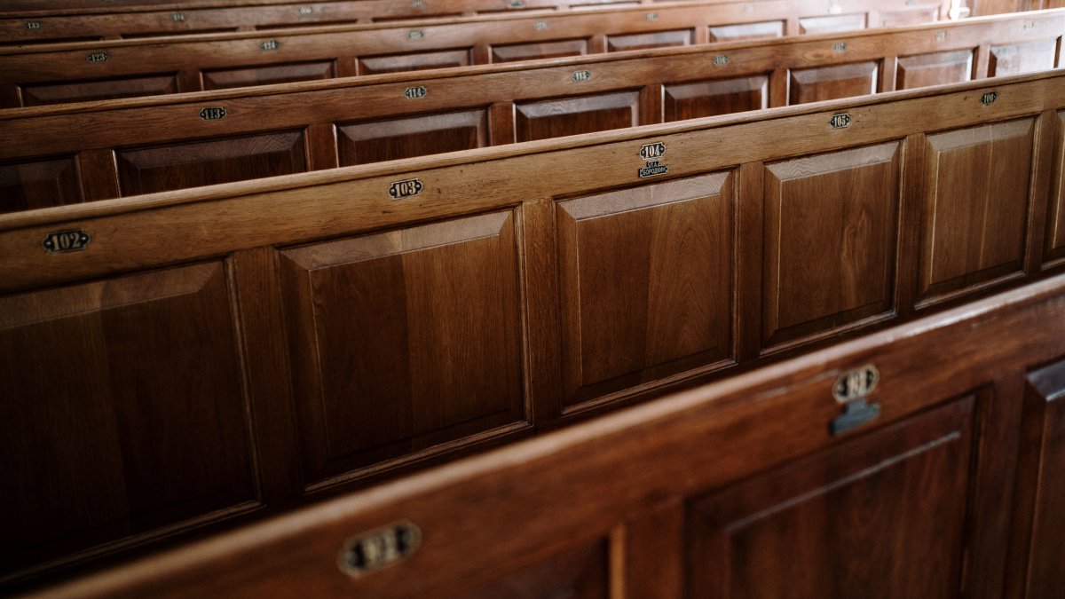 Close-up of wooden church pews showcasing detail and finish.