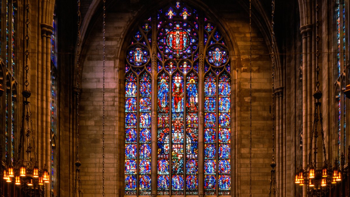 Colorful stained glass window in a Gothic style church